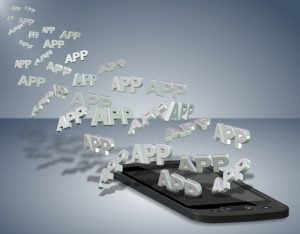 The word "app" floating over mobile phone 