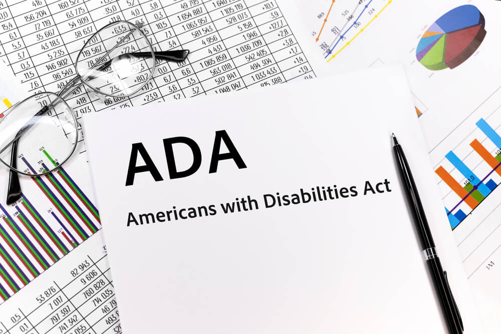 ADA compliant_ADA Americans with Disabilities Act Concept. the inscription on the sheet. pen, glasses, documents, graphics.