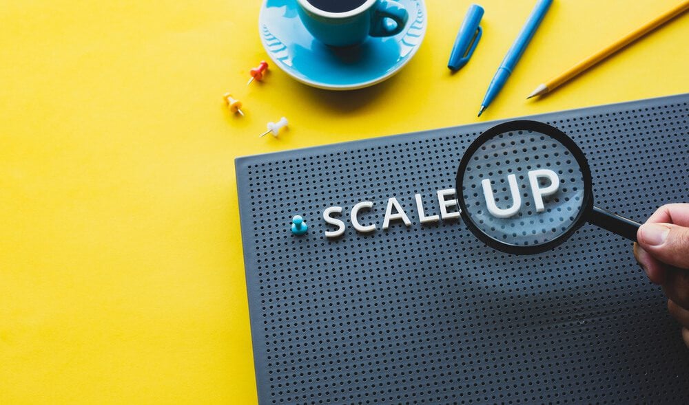 scalability_Scale up or startup business concepts with magnifying glass on text.performance of investment