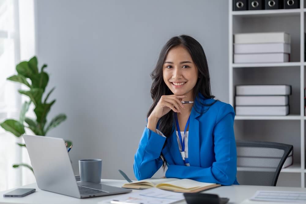 CMO_Young beautiful asian woman working in corporate office, businesswoman working in office attentively to grow and modernize start-up business, she is analyzing company's market and financial data.