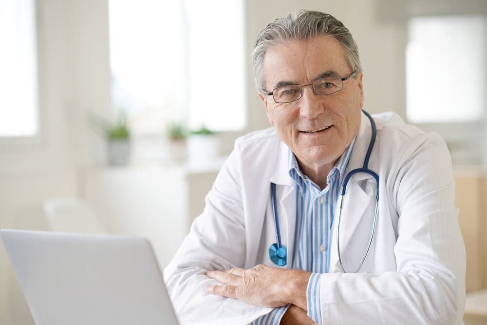 ppc for doctors_Portrait of senior doctor sitting in medical office