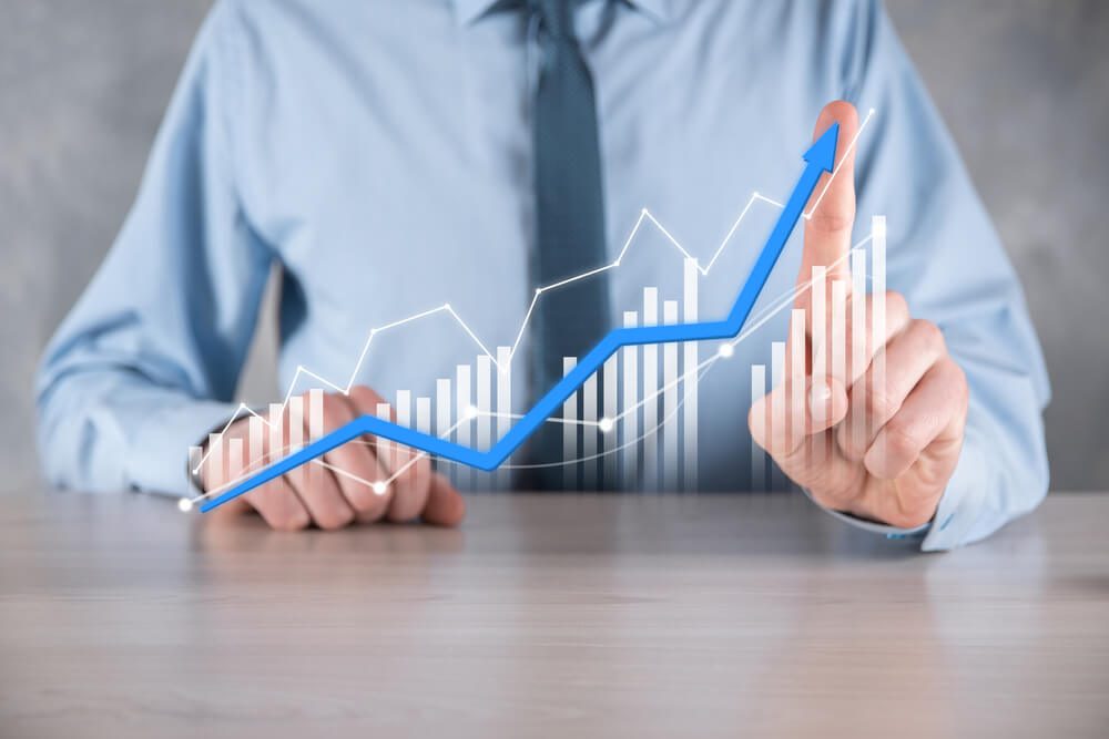 demand generation_Businessman man holding a graph with positive profits growth. plan graph growth and increase of chart positive indicators in his business.more profitable and growing.