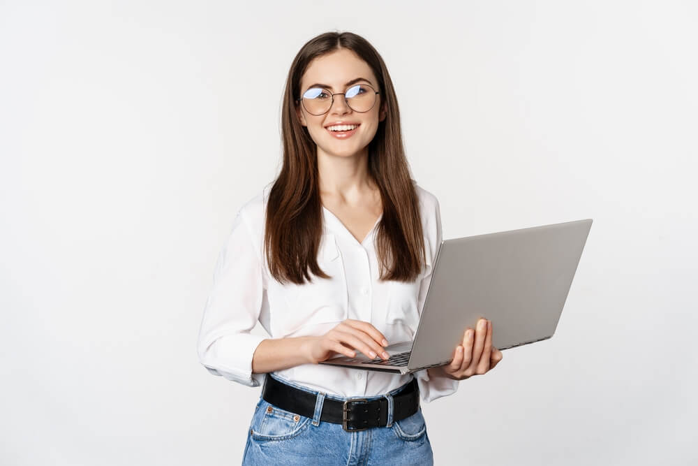 digital consultant_Portrait of young office woman, entrepreneur answer clients on laptop, working with computer with happy face, standing over white background