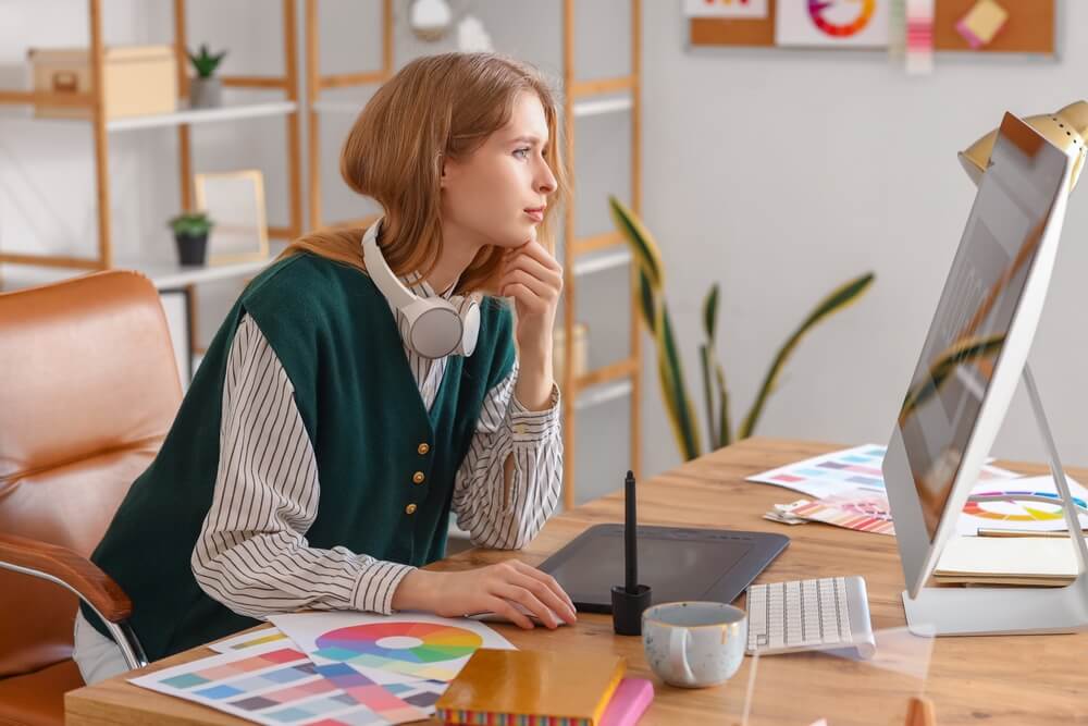 graphic designer_Female graphic designer working with computer at table in office