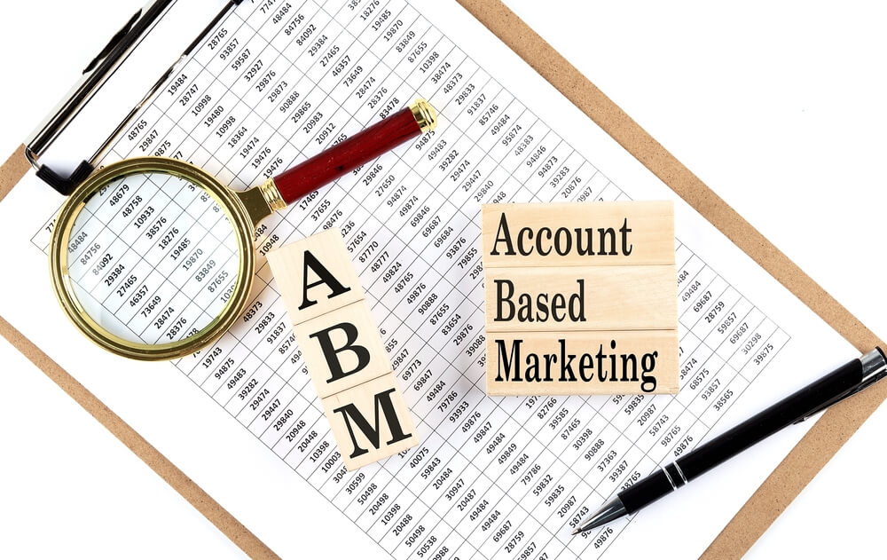 ABM_ABM Account Based Marketing text on wooden block on a chart background