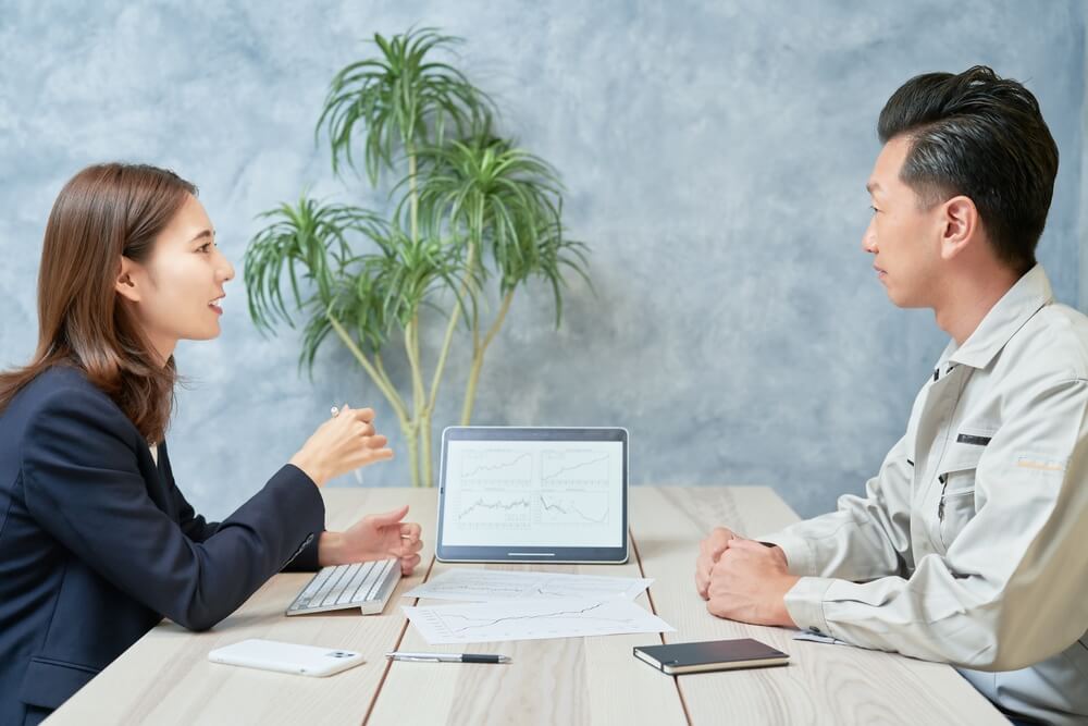 fractional CMO_A woman in a suit meeting with a man in work clothes