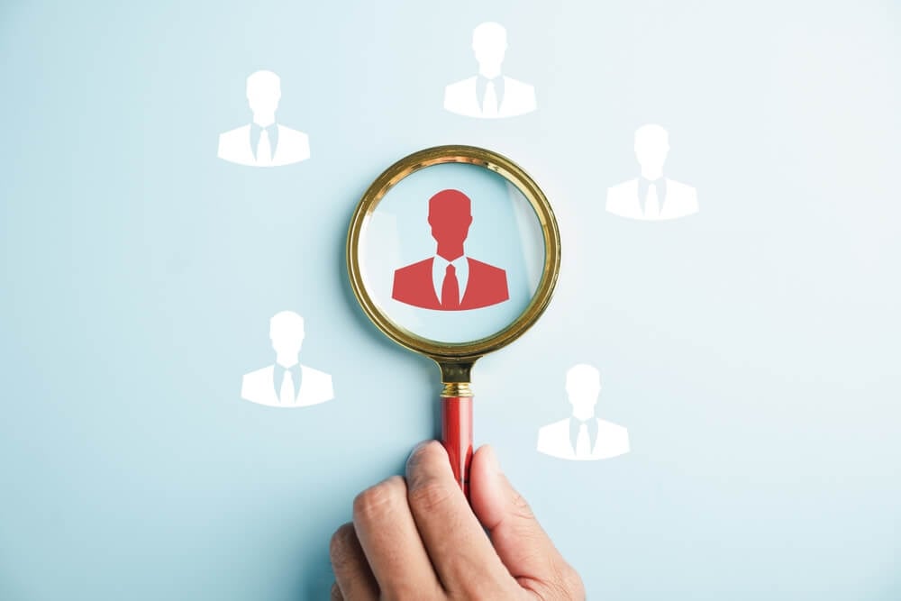 marketing position_HRM vision Magnifier glass zooms in on manager icon, symbolizing the strategic role of human resource management in human development, recruitment, and leadership. employees selection