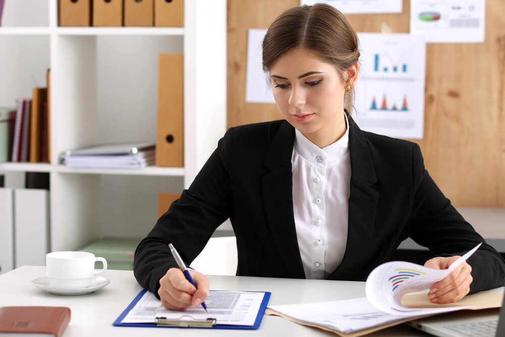 CMO_Beautiful businesswoman sit at workplace in office work with papers portrait. Serious business, exchange market, job offer, analytics research, excellent education, certified public accountant concept