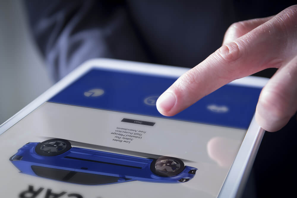 car website_finger touches digital tablet showing car website on screen