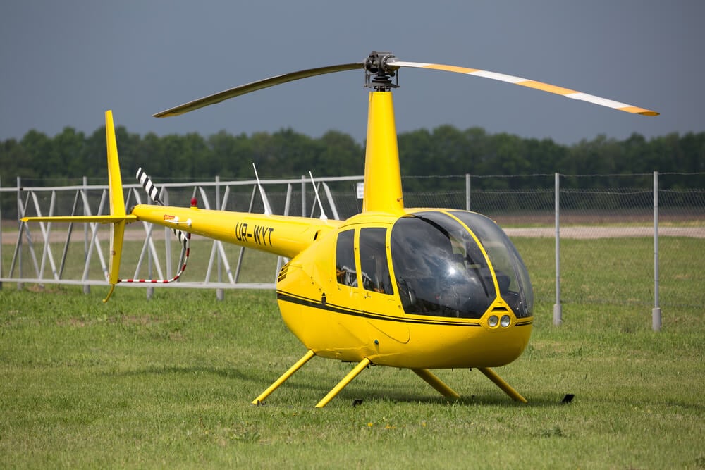 helicopter tour company_Devichki, UKRAINE - MAY 01, 2014: Helicopter Robinson R44 at private airfield. Private helicopter. Business aviation.