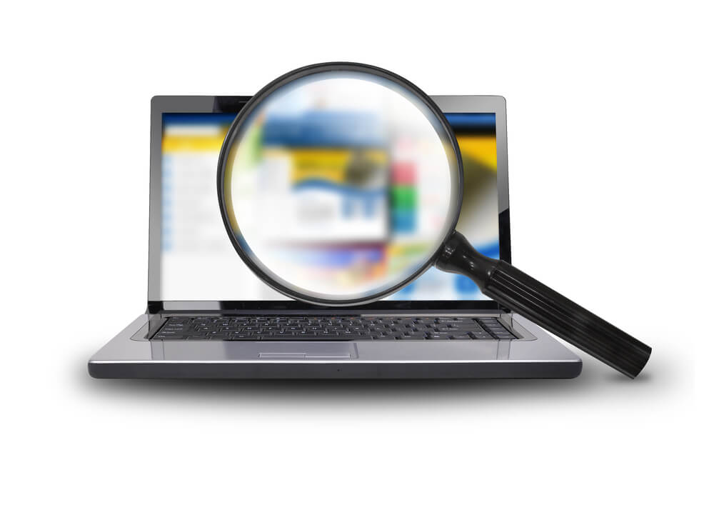 website optimization_A computer laptop is isolated on a white background with a magnifying glass searching the internet.