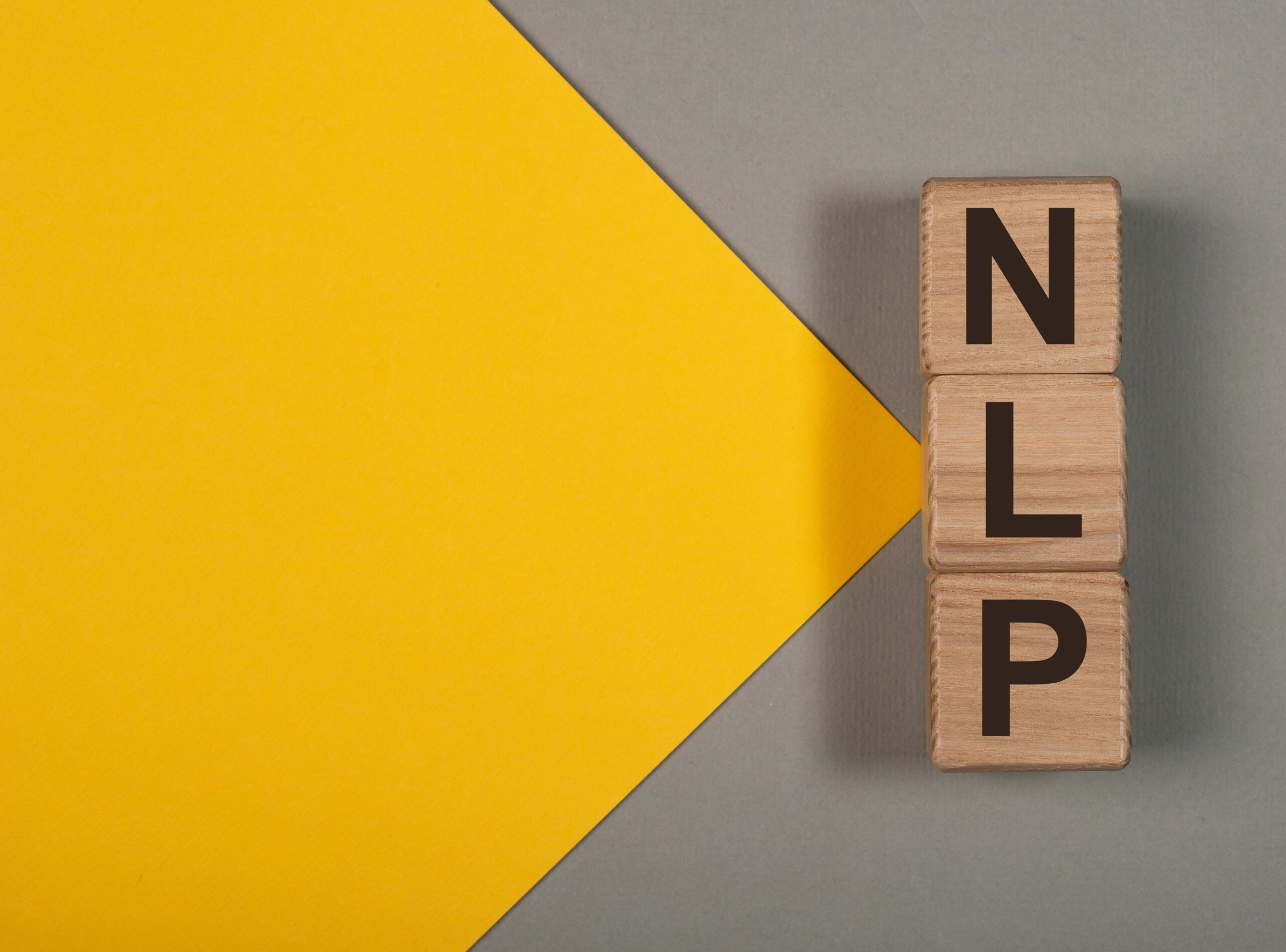 A yellow triangle points to letters (NLP) on wooden blocks to represent NLP parts integration