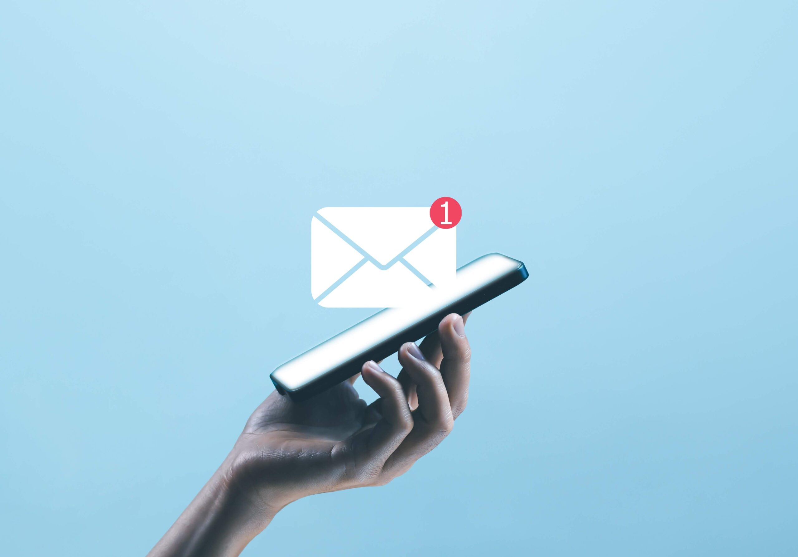 An email with one unread message icon pops out of a smartphone in an email marketing for nonprofits expert's hand