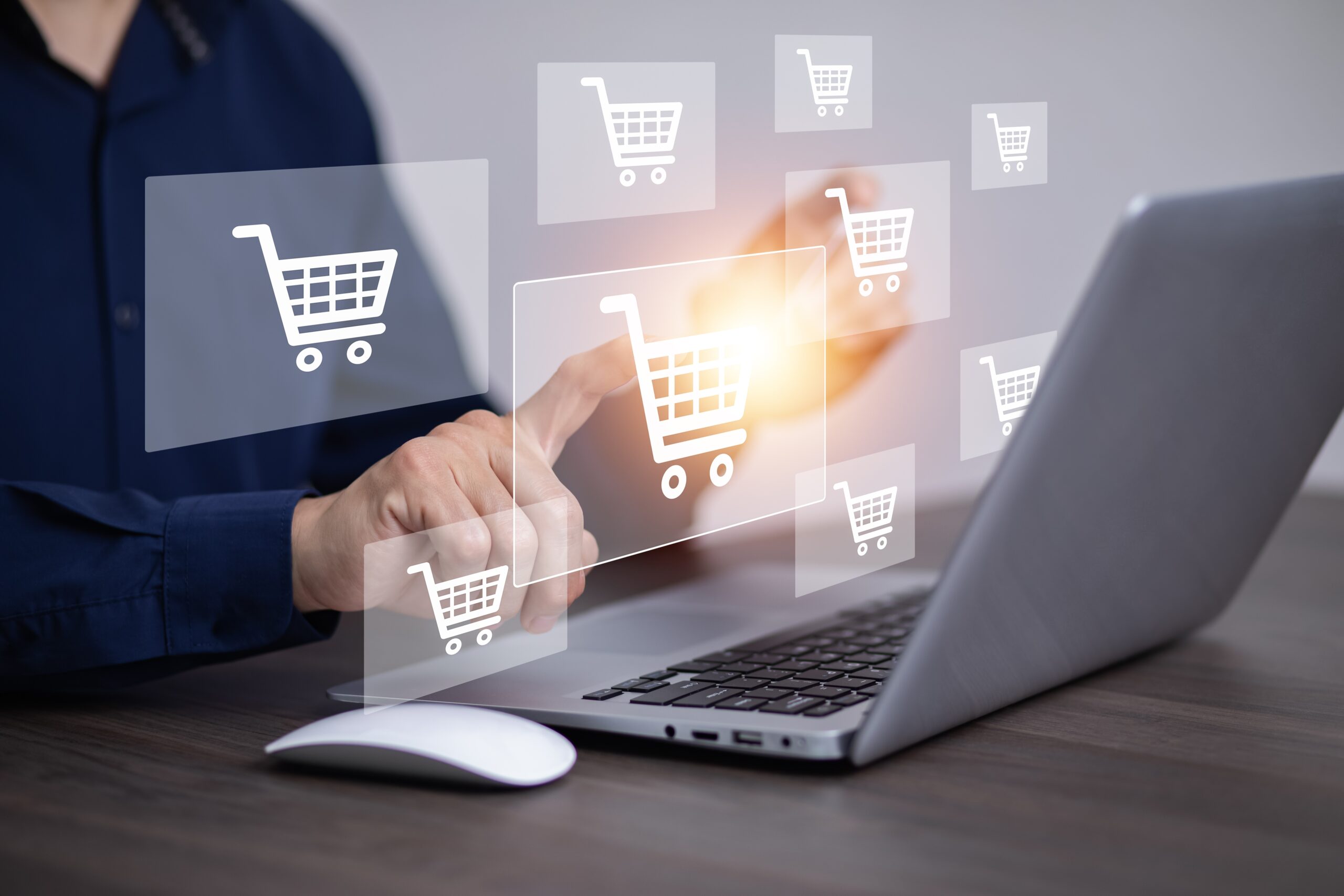 A Chicago FCMO for retail customer loyalty points at floating icons of shopping carts above his silver laptop and white mouse