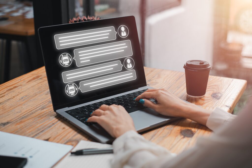 A woman types to an AI chatbot on her laptop, thanks to the fractional CMO for Chicago NLP integration
